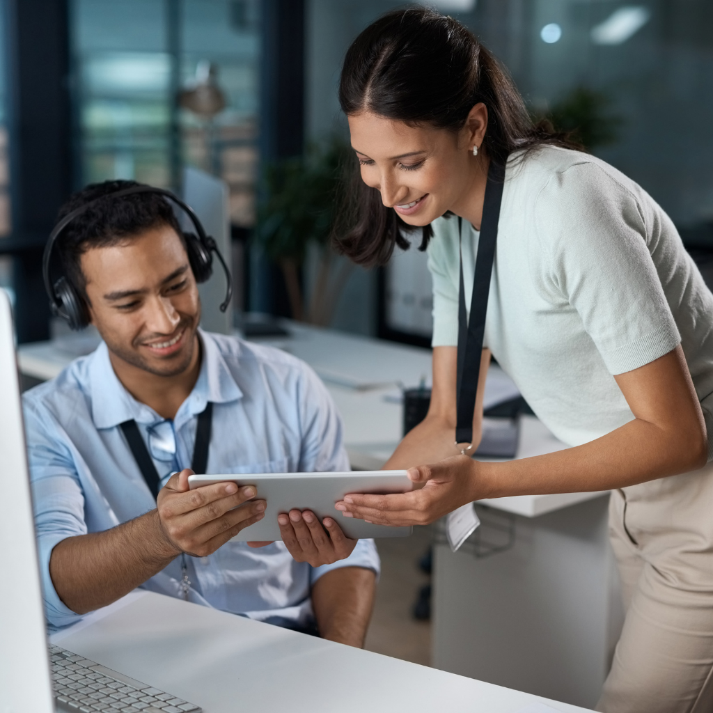 A person guiding another person using a tablet.