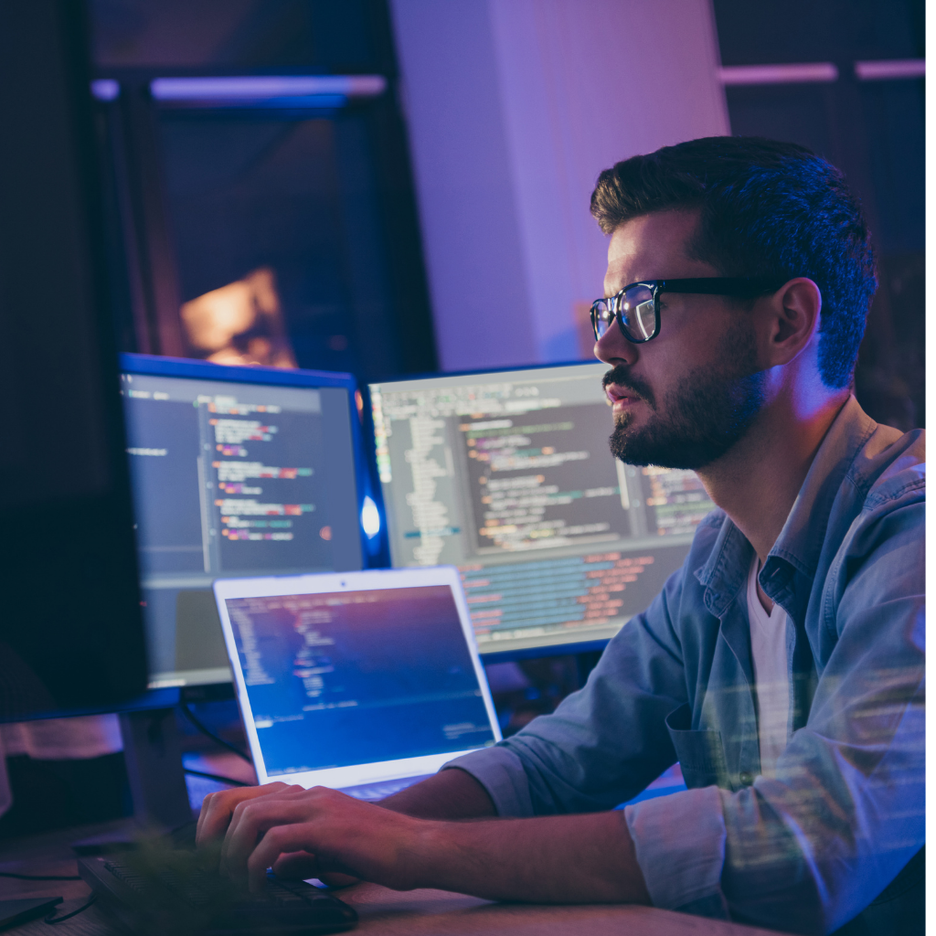 A man viewing multiple screens